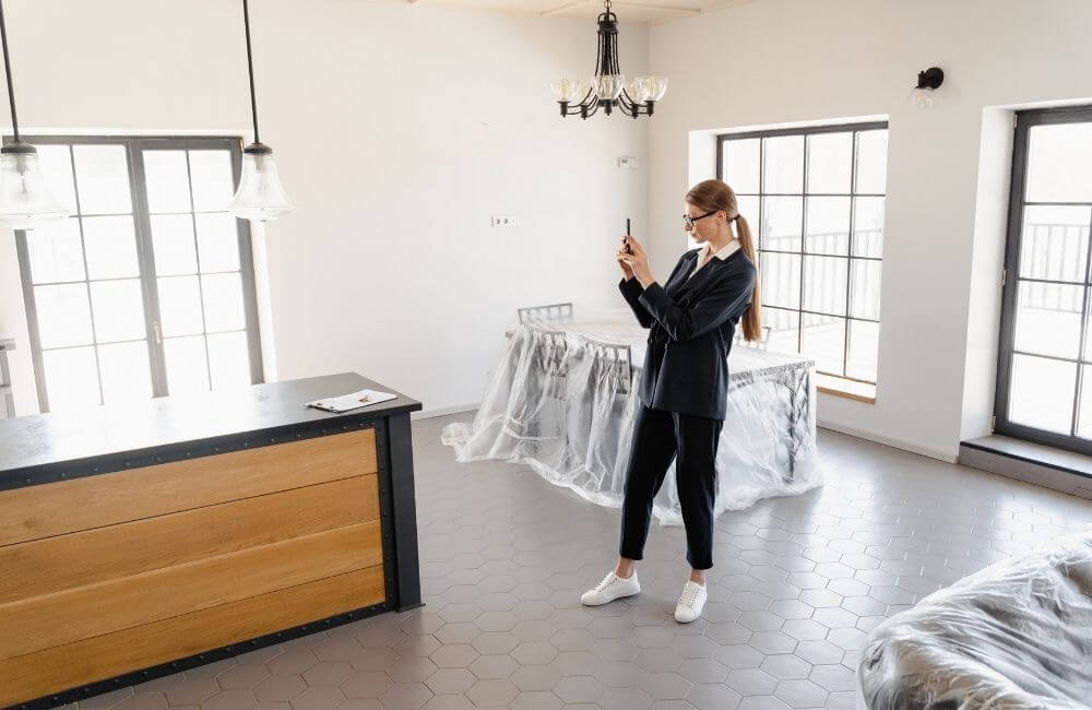 woman taking photo of home